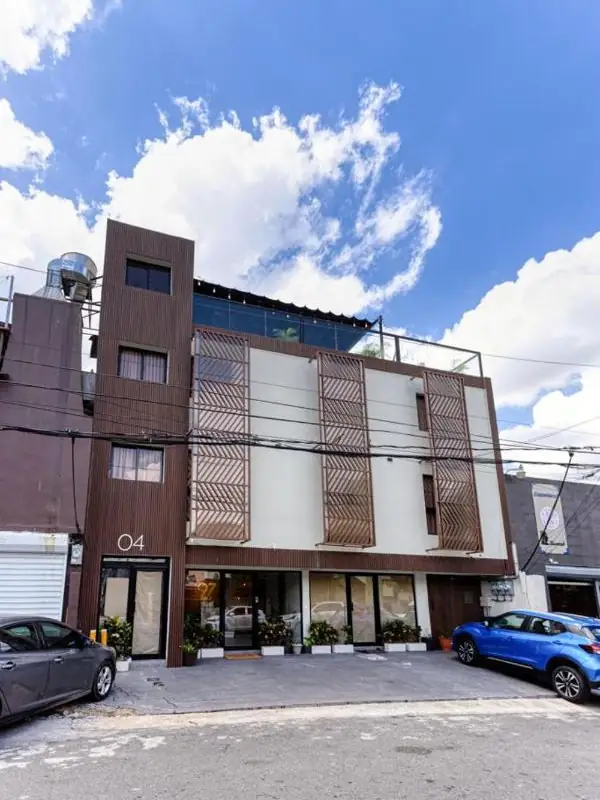 The front of Studio 27, a four-storey building with wooden panels in central Santo Domingo